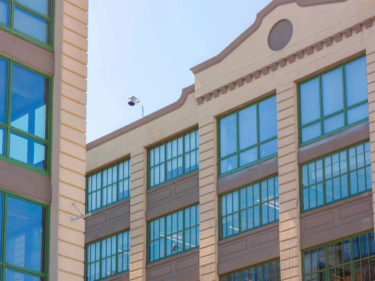 Building elevation with rows of aluminum-framed windows as the focal subject.